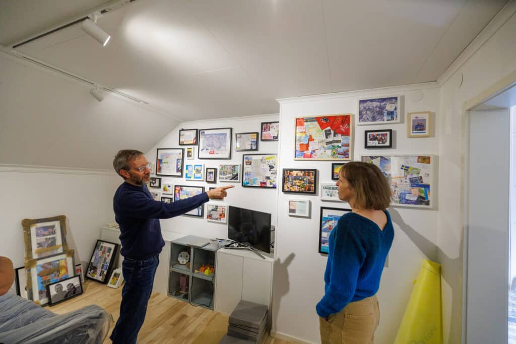 The Bramble couple at a wall of photos