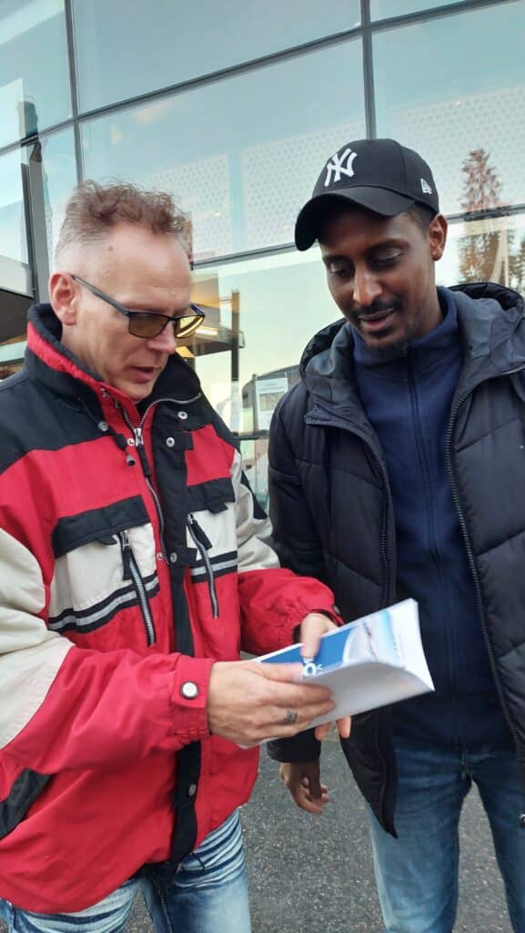 Axel and Omar looking at brochures about Boden outside the Defense Museum