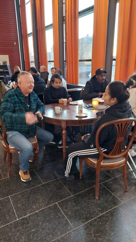 Coffee and conversation around a table at the Defense Museum Boden