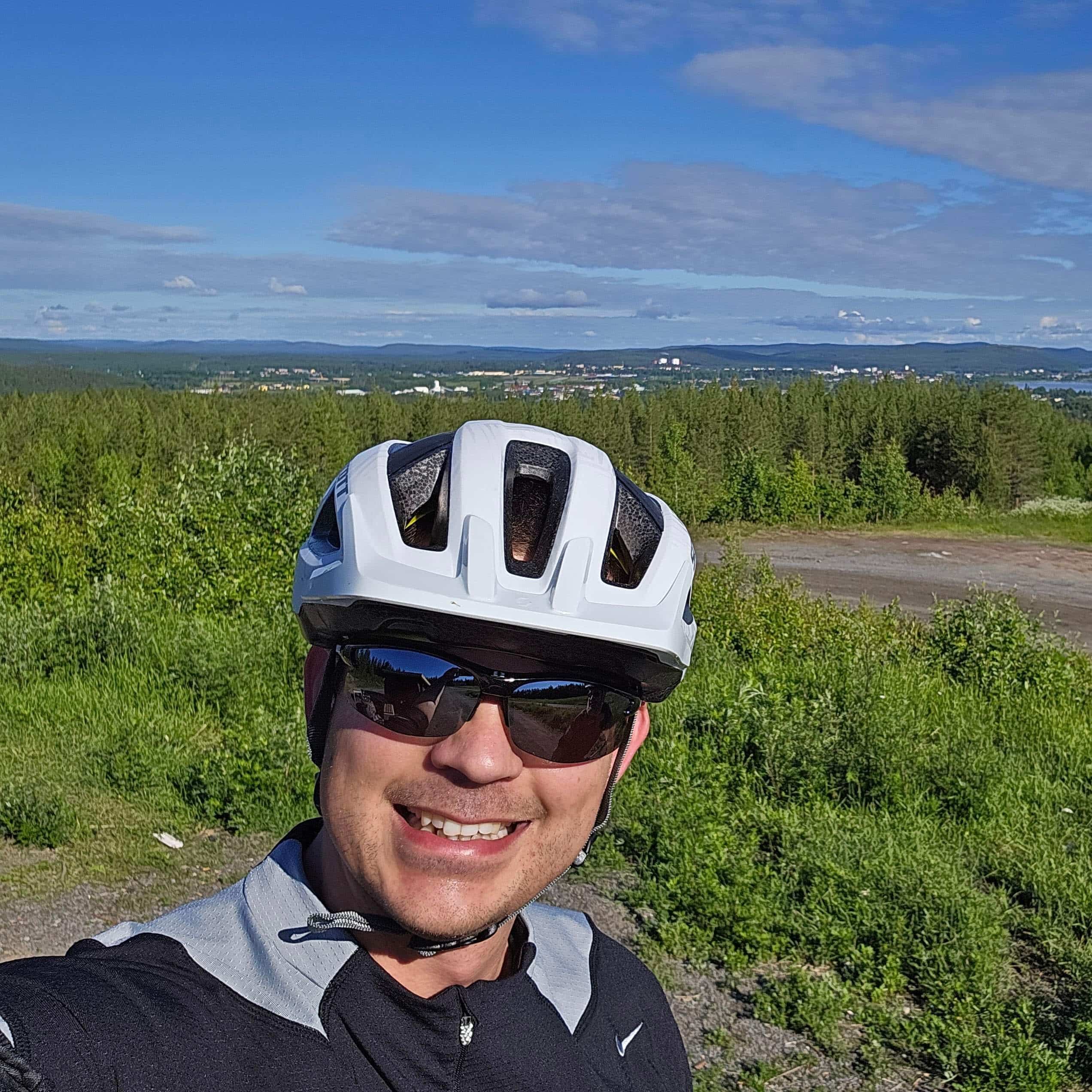 Man in bicycle helmet with nice view